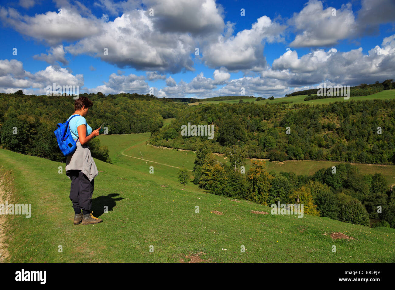 Woman rambler reading a map on the South Downs. Stock Photo