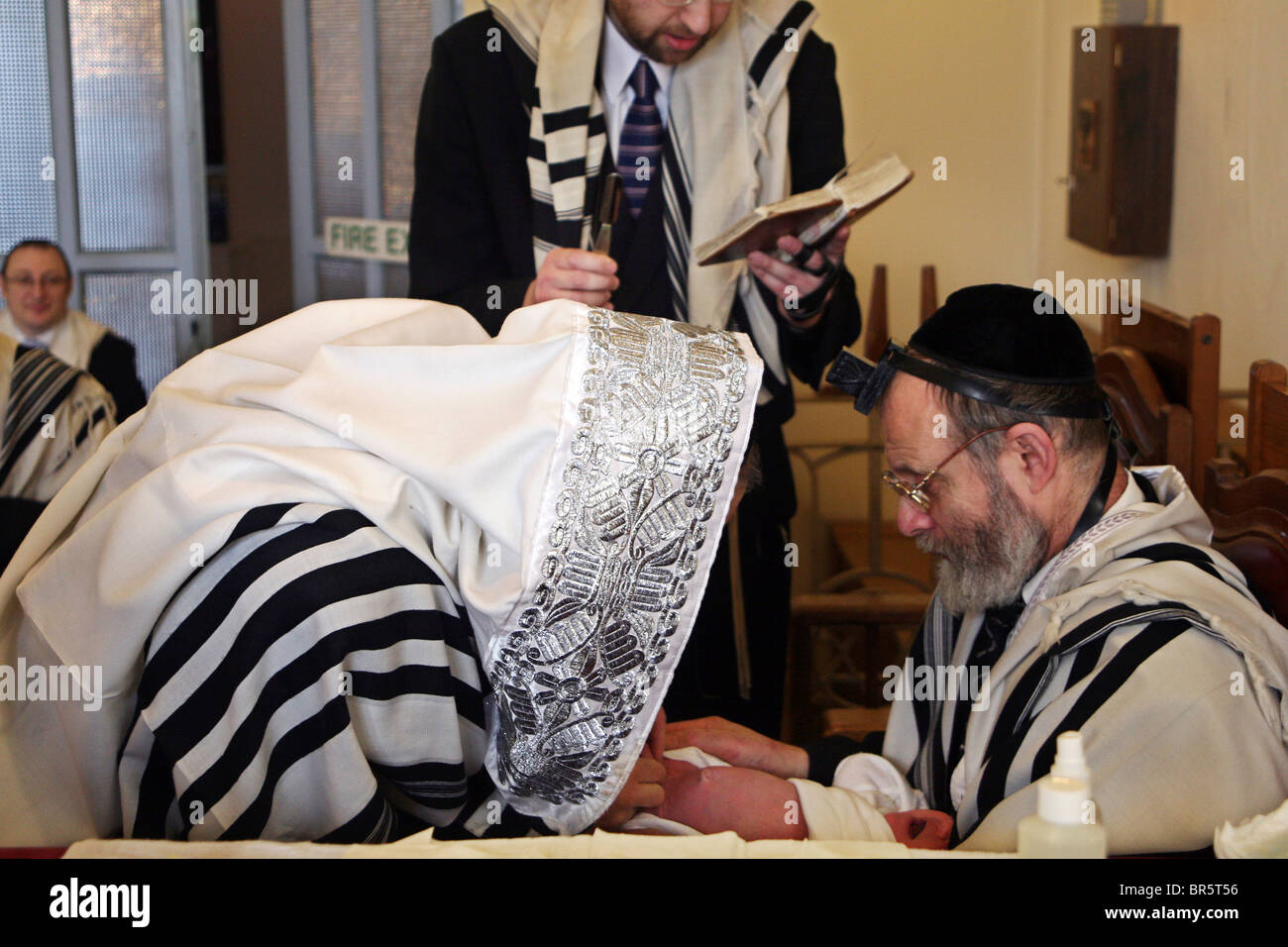 The Mohel performs a circumcision ceremony. On the 8th day after birth a Brit Milah is performed. Stamford Hill, London. Stock Photo