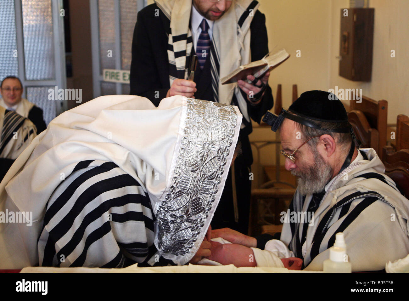 The Mohel performs a circumcision ceremony. On the 8th day after birth