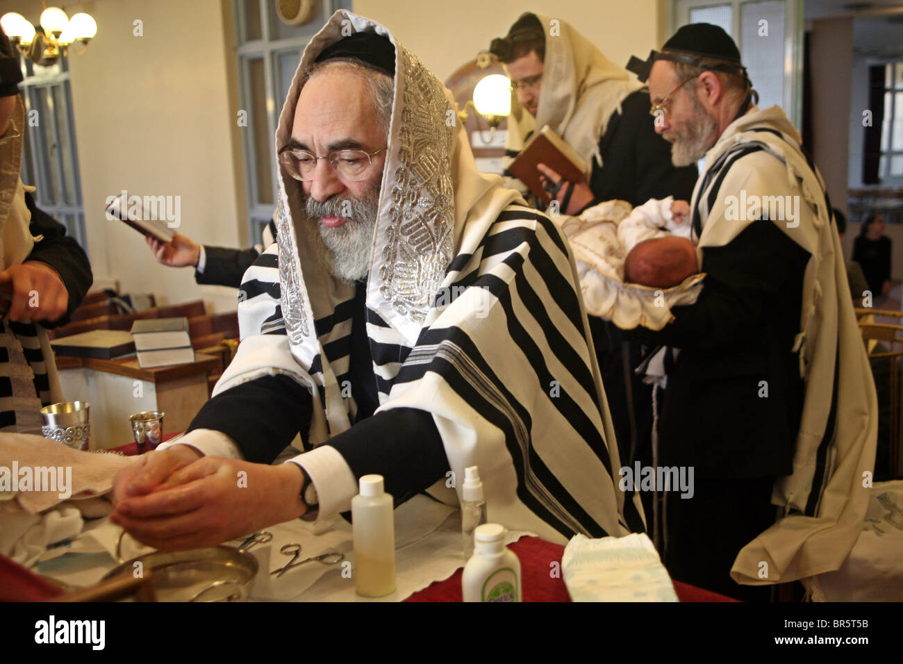 The Mohel washes his hands before the circumcision ceremony begins. On the 8th day after birth a Brit Milah is performed. Stock Photo