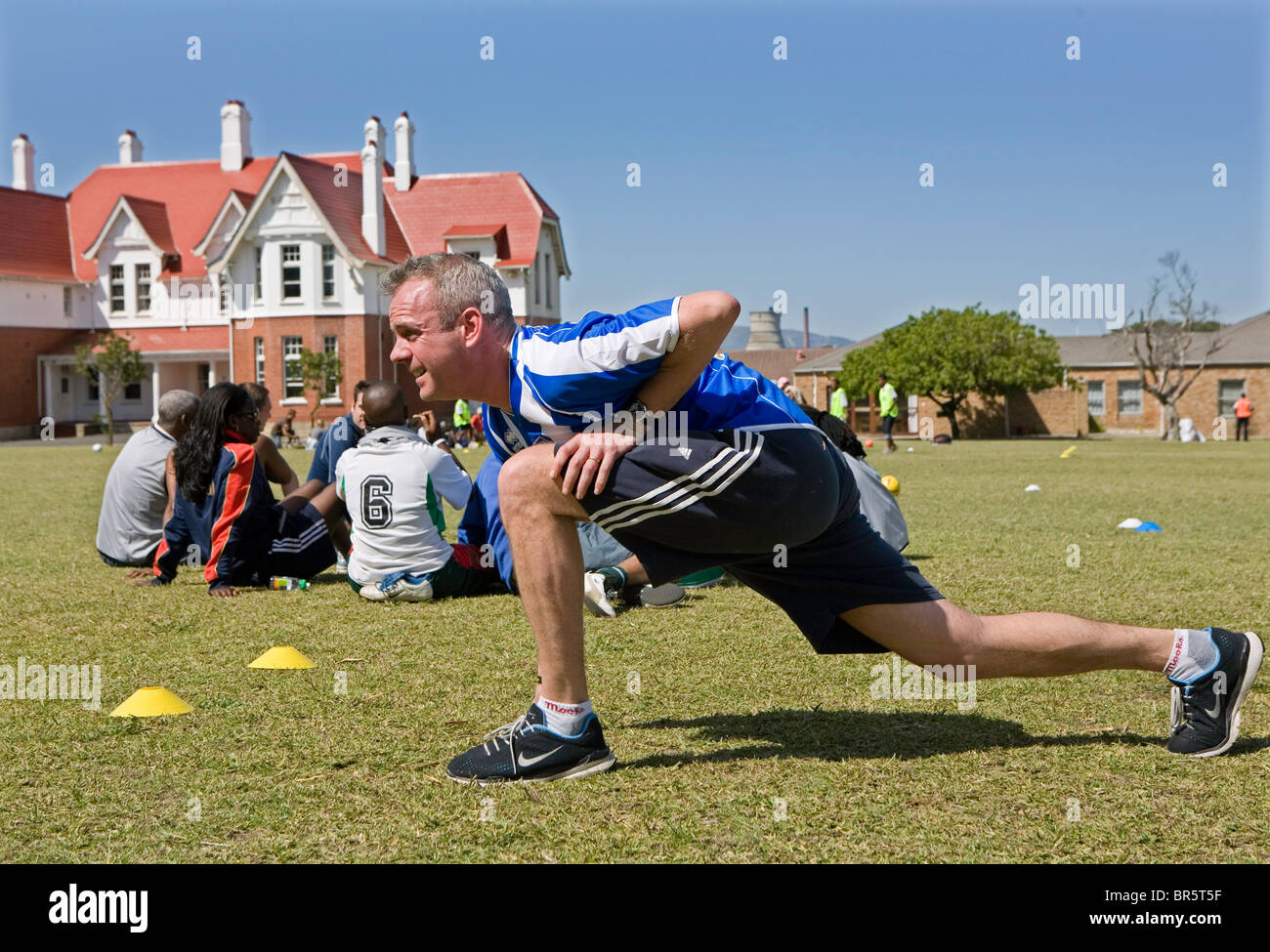 Norman Cook warms up in football attire in South Africa where they are helping the charity, Coaching for Hope. Stock Photo