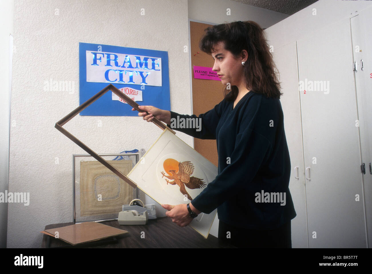 Hispanic woman prepare frame mount art display insert shop store