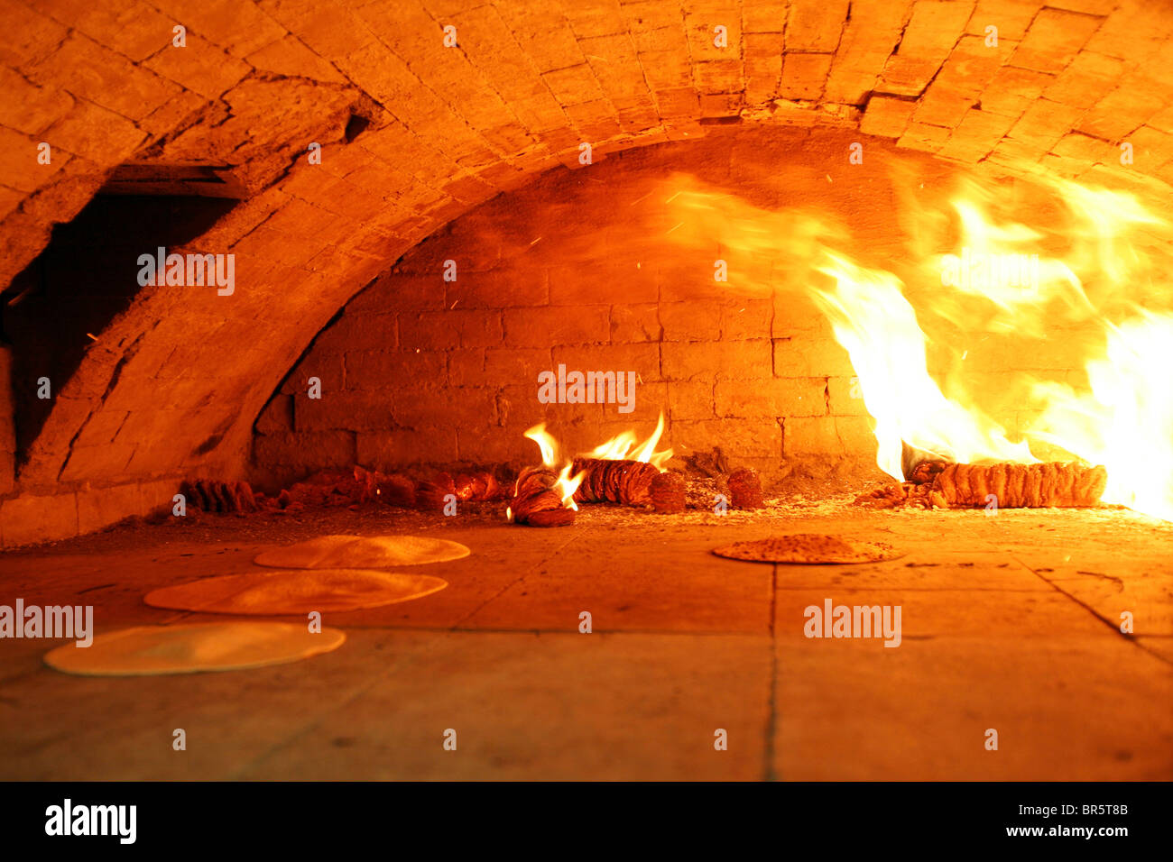 Matza bread baking in a traditional brick oven for Passover, the oven