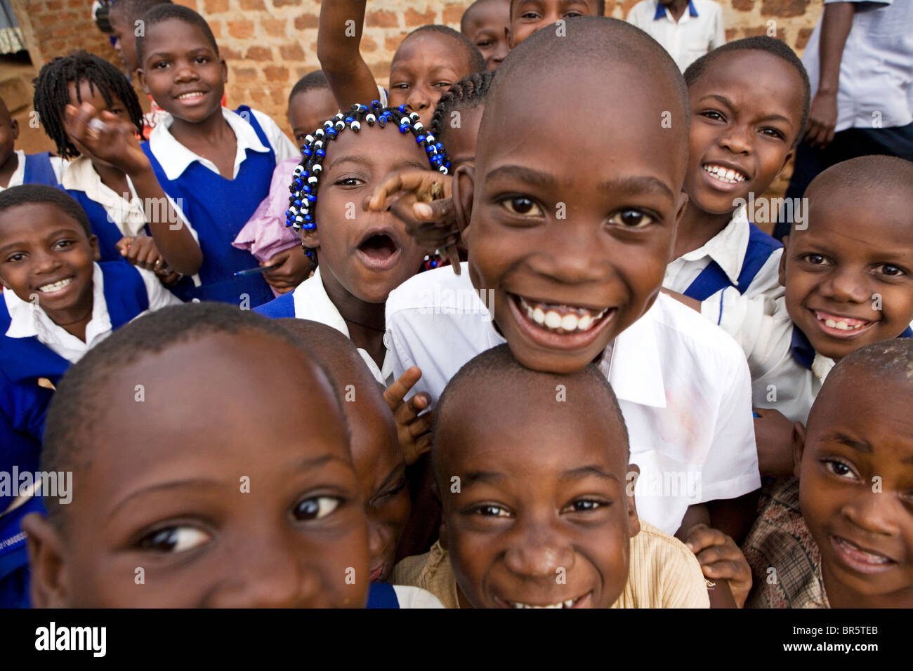 School children happy to finish for the day from a primary school near Kalerwe market, Kampala, Uganda, Stock Photo