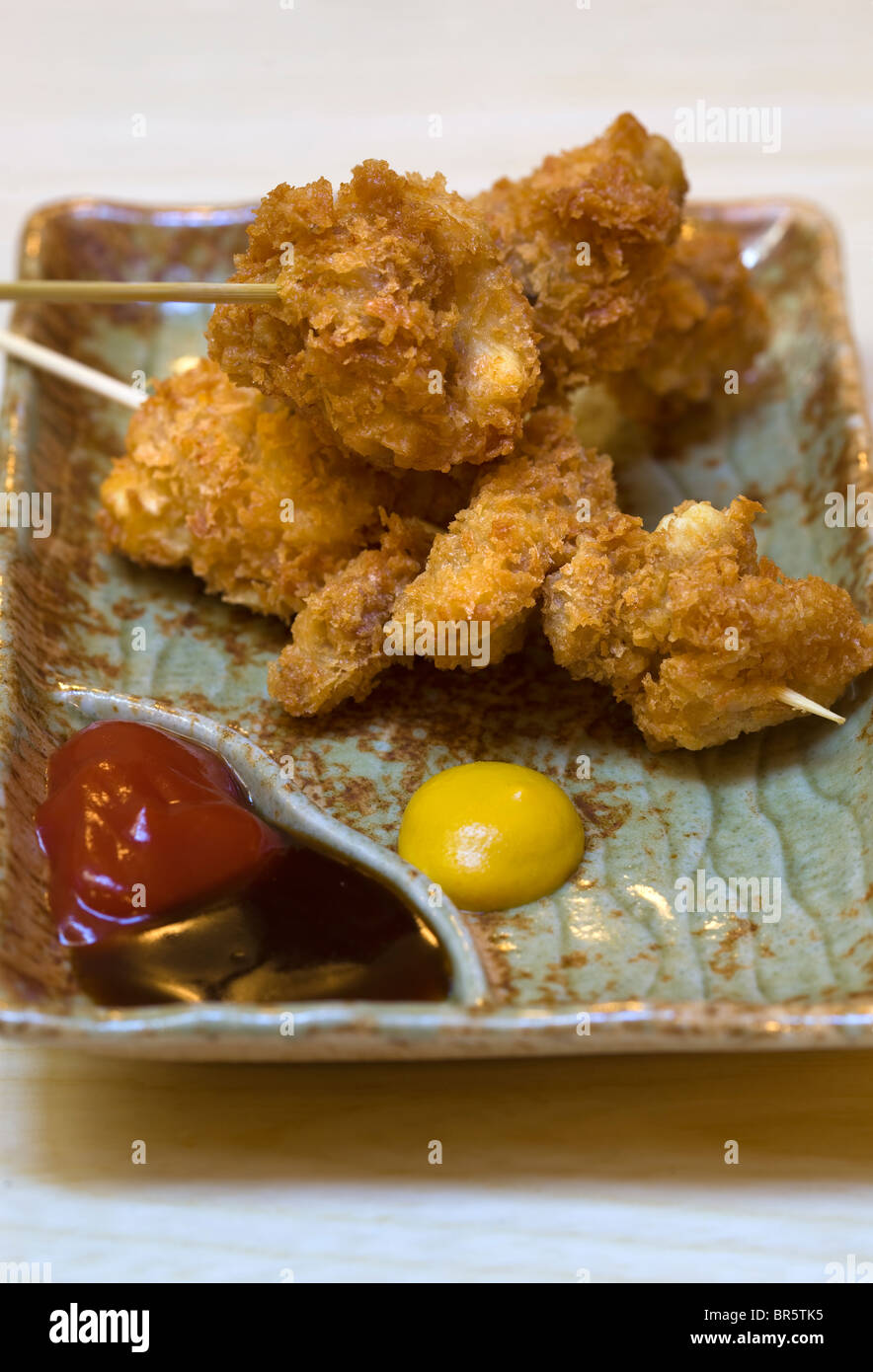 Crispy Fried Chicken on skewers with sauce Stock Photo