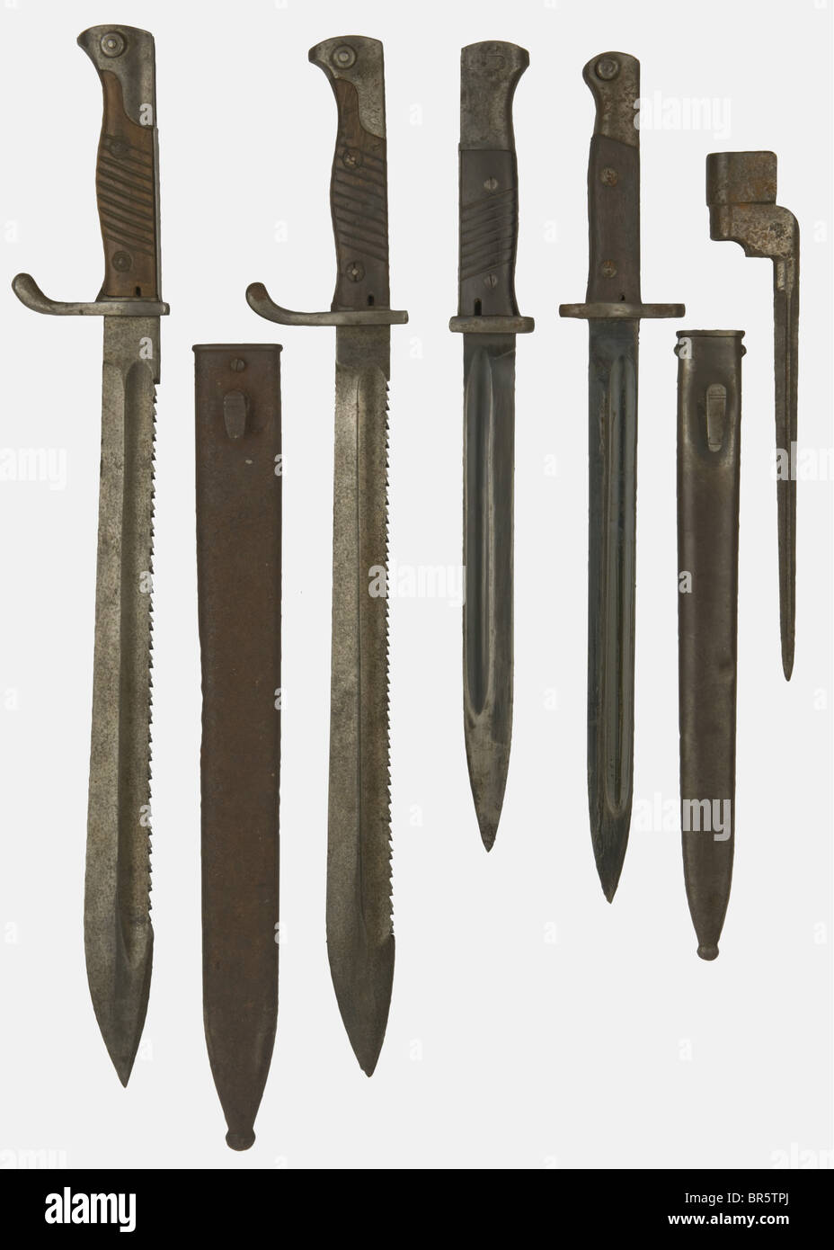A group of edged weapons, including a German pioneer saw-back bayonet pattern 98/05, no number or maker's mark visible (corroded), with its scabbard, a German pattern 84/98 bayonet, stamped on the blade 'Gebr. Heller', with bakelite grip scales, WAA stamping 1937, no scabbard, a German pioneer saw-back bayonet pattern 98/05 made by the Imperial Erfurt arsenal, no scabbard, a Mauser export bayonet FN 1908 used mainly on the Yugoslavian Mauser pattern 1924, and a British spike bayonet without scabbard. historic, historical, 1900s, 1920s, 1930s, 20th century, 20th, Stock Photo