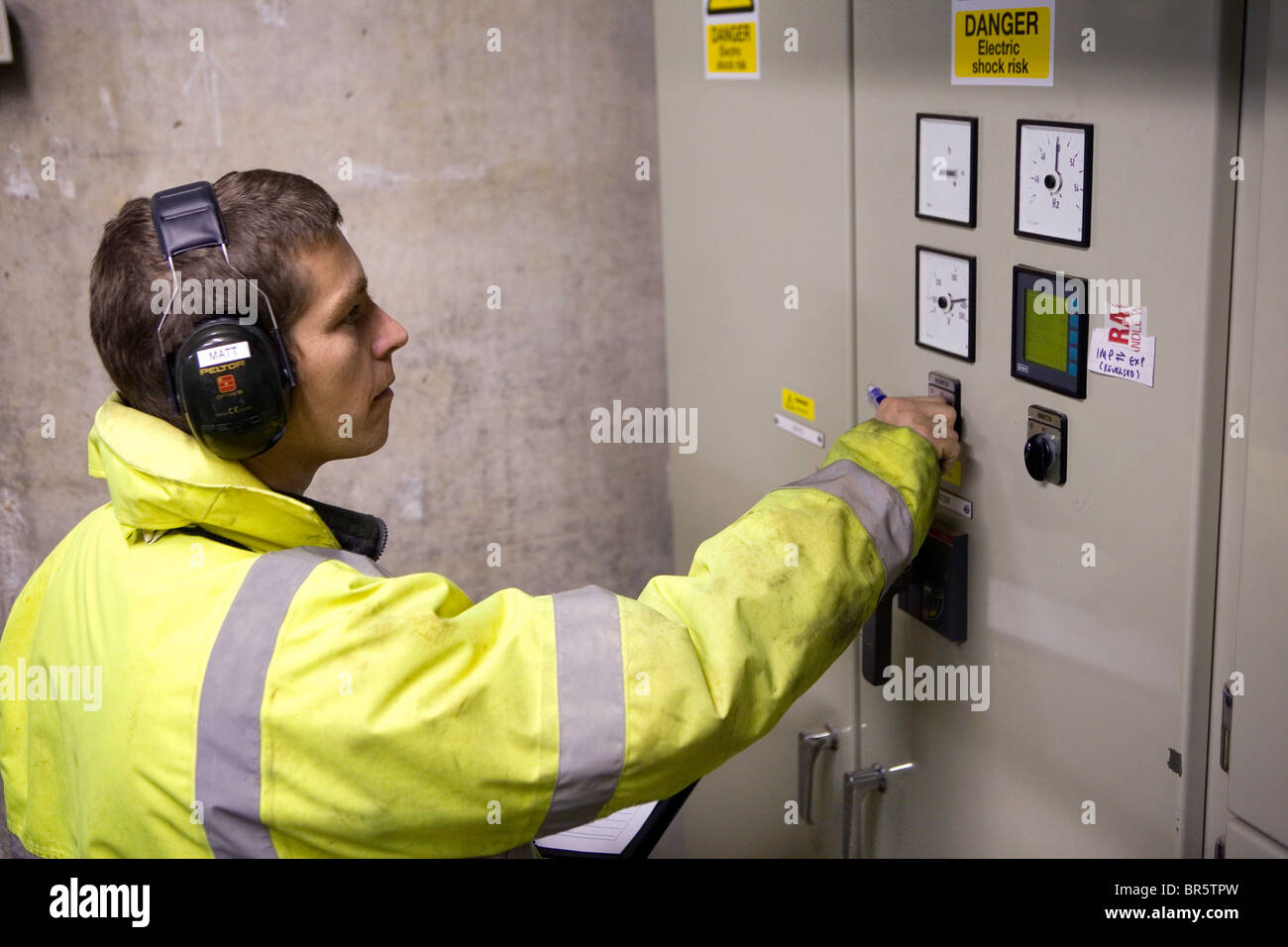 Engineer checking power levels at Hydro plant in Powys, Wales