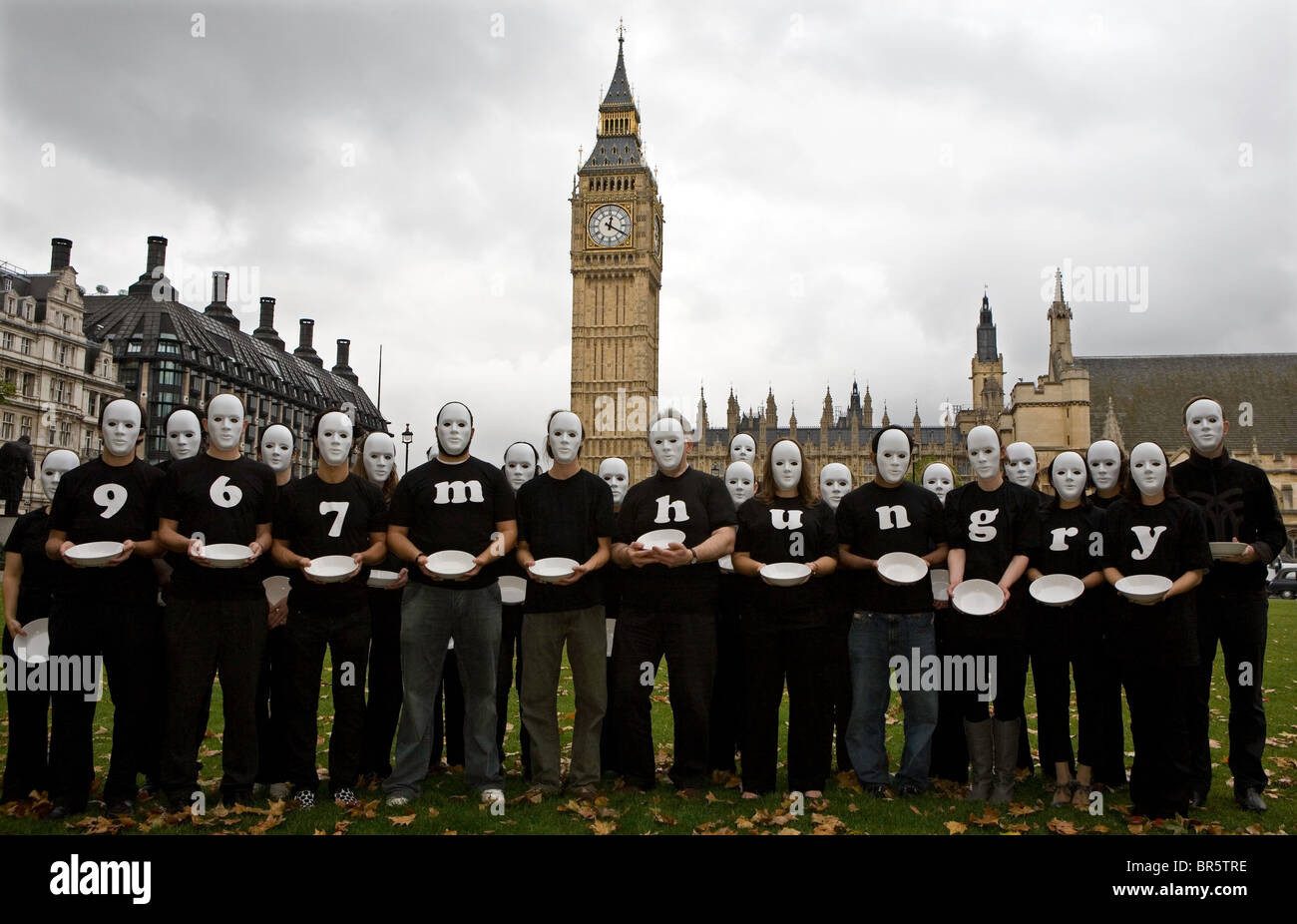 On World Food Day, Oxfam launches an appeal about rising world food prices. Faceless masks, empty bowls at Houses of Parliament. Stock Photo