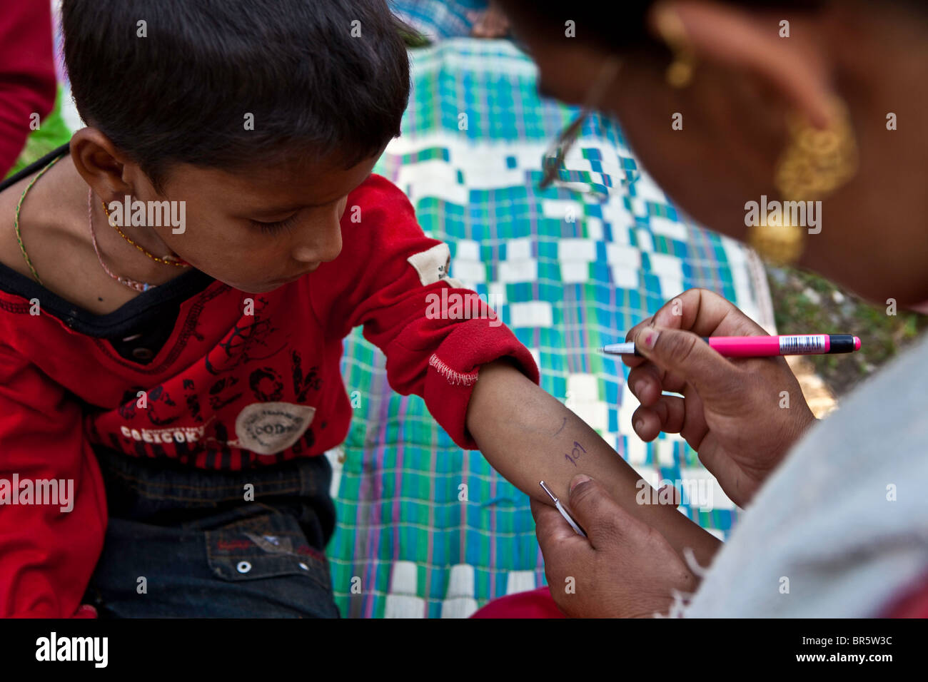 Child at mobile health clinic in the Gagan Gauda, Kaski District Pokhara, that is run by the Child Welfare Scheme, Nepal. Stock Photo
