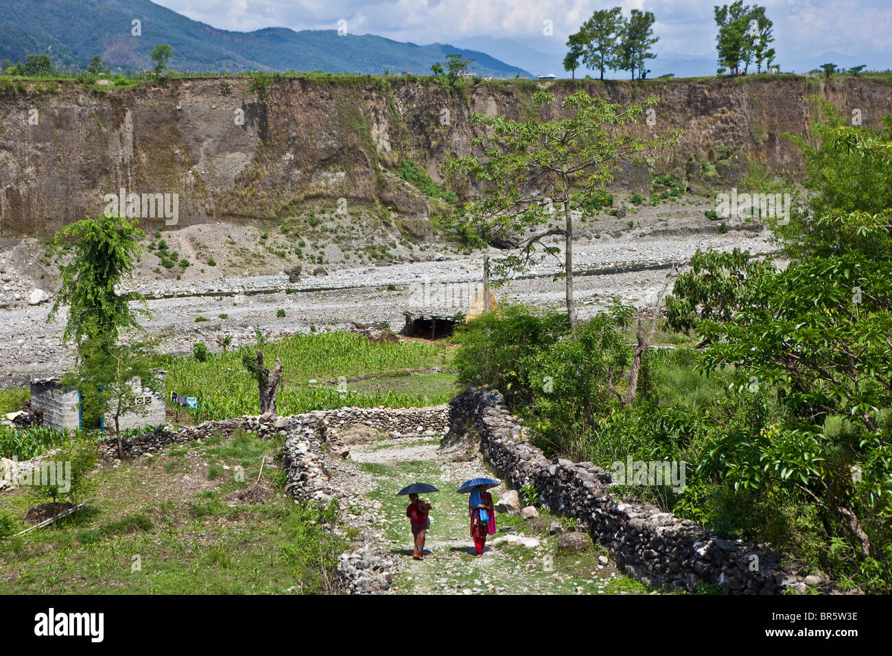 Women arriving with their children to the mobile health clinic across the rough terrain of the region. Nepal Stock Photo