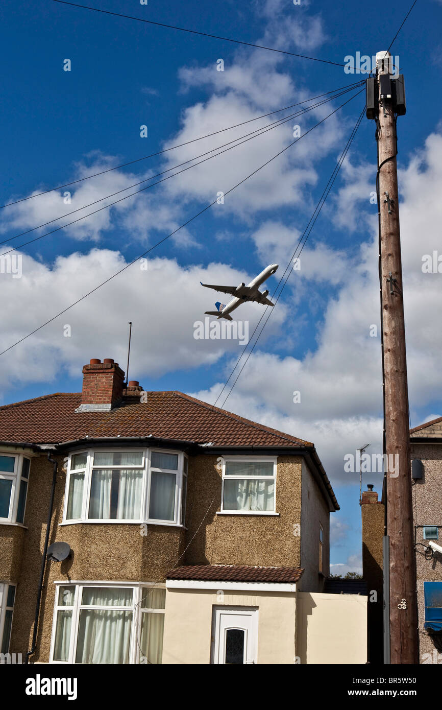 A plane taking off from London’s Heathrow Airport and flying over the Hatton Cross area of Hounslow Borough. Stock Photo