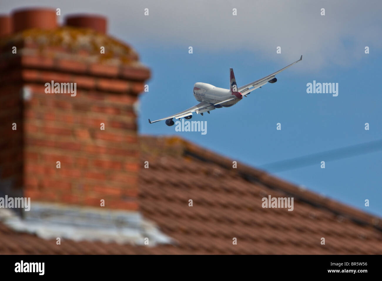 A plane taking off from London’s Heathrow Airport, and flying over the Stanwell area of Hounslow Borough. Stock Photo