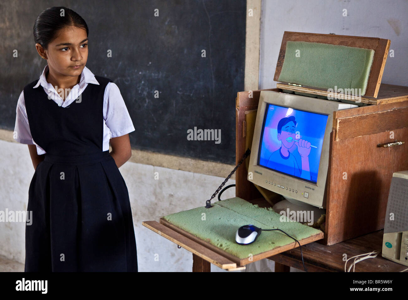 A volunteer from a local private school helping with an IT lesson as part of the Shaishav Trust’s Mobile Resource Centre. Stock Photo