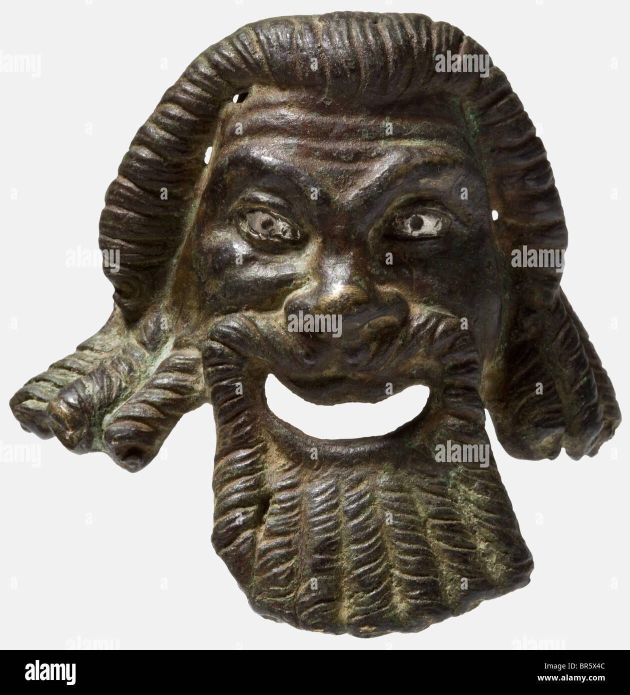 A Roman theatre mask, 3rd - 4th century A.D. Bronze cast complemented