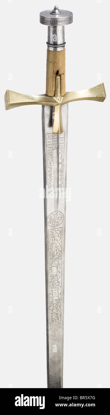 Ali Dinar ibn Zakariya, Sultan of the Sudan (1865 - 1916), a silver-mounted presentation sword (kaskara) for Salatin Basha, dated 1910 Massive double-edged blade with richly etched inscription cartouches on both sides, including two magic squares, Islamic religious texts, three poems, and a long inscription to the effect that this sword was a gift from Sultan Ali Dinar to Salatin Basha in 1328 (= 1910). Massive brass quillons with finely engraved tughras on the finials bearing the names "Ali Dinar" and "Salatin Basha in 1328" respectively. Round wooden grip wit, Stock Photo