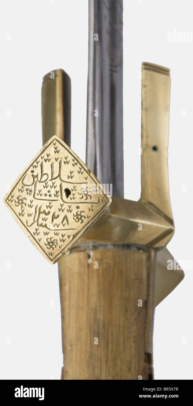 Ali Dinar ibn Zakariya, Sultan of the Sudan (1865 - 1916), a silver-mounted presentation sword (kaskara) for Salatin Basha, dated 1910 Massive double-edged blade with richly etched inscription cartouches on both sides, including two magic squares, Islamic religious texts, three poems, and a long inscription to the effect that this sword was a gift from Sultan Ali Dinar to Salatin Basha in 1328 (= 1910). Massive brass quillons with finely engraved tughras on the finials bearing the names 'Ali Dinar' and 'Salatin Basha in 1328' respectively. Round wooden grip wit, Stock Photo