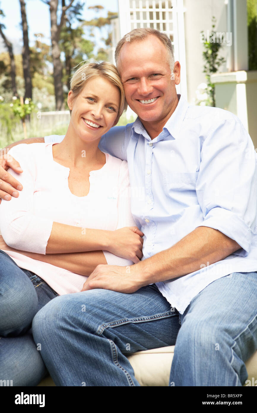 Couple Relaxing In Garden Stock Photo