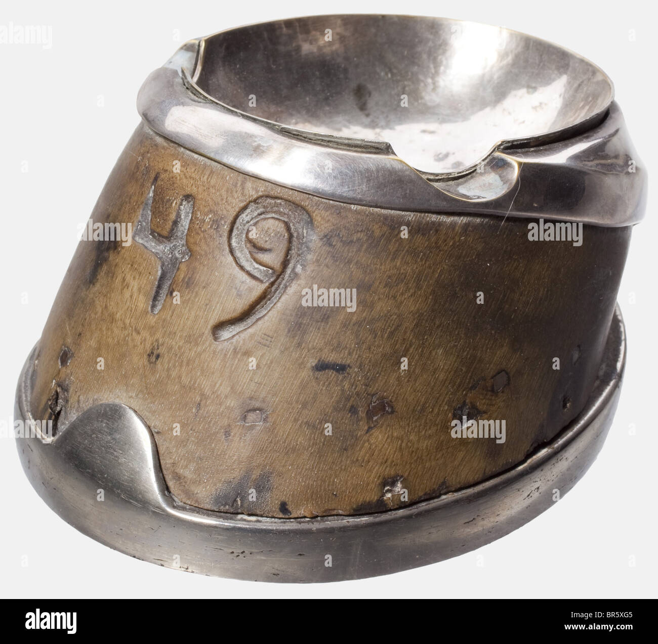 Oberleutnant Ernst Schultze-Moderow, a colonial ashtray Horn of a horse's hoof, silver-plated brass and nickel-plated steel horseshoe. The number '49' is deeply carved into the horn. Height circa 7 cm. According to the family's tradition it is made from the hoof of his horse during his time in South West Africa. historic, historical, 1900s, 1910s, 20th century, navy, naval forces, military, militaria, branch of service, branches of service, armed forces, armed service, object, objects, stills, clipping, clippings, cut out, cut-out, cut-outs, utensil, piece of e, Stock Photo