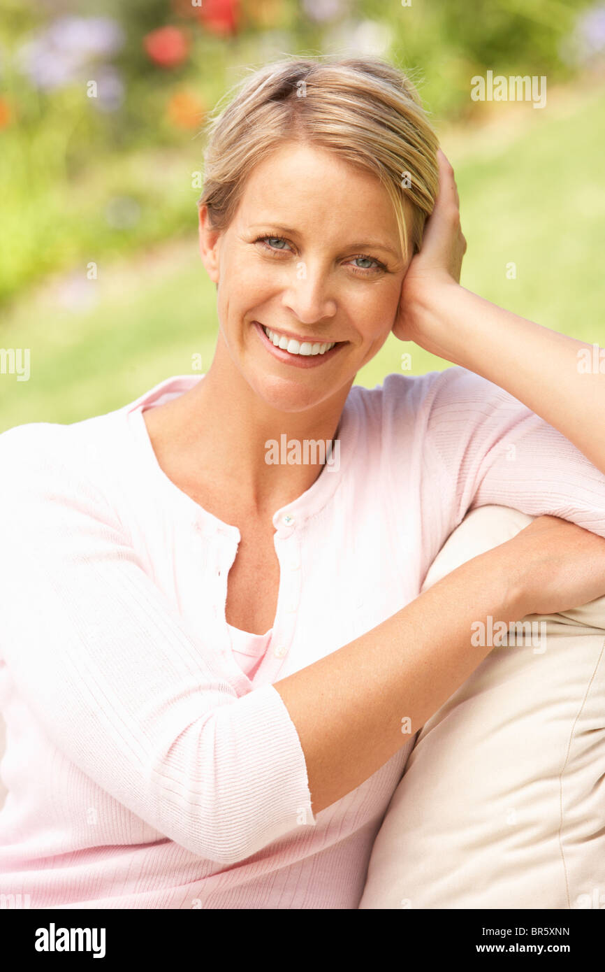 Young Woman Relaxing In Garden Stock Photo - Alamy