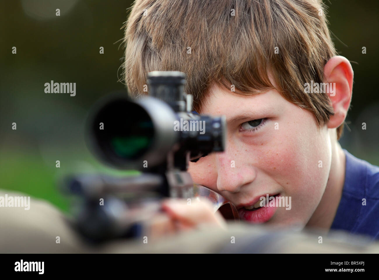 13 year old boy aiming airgun at a demonstration event at Hampshire County Sports Day, Alresford, Hampshire, UK. Stock Photo