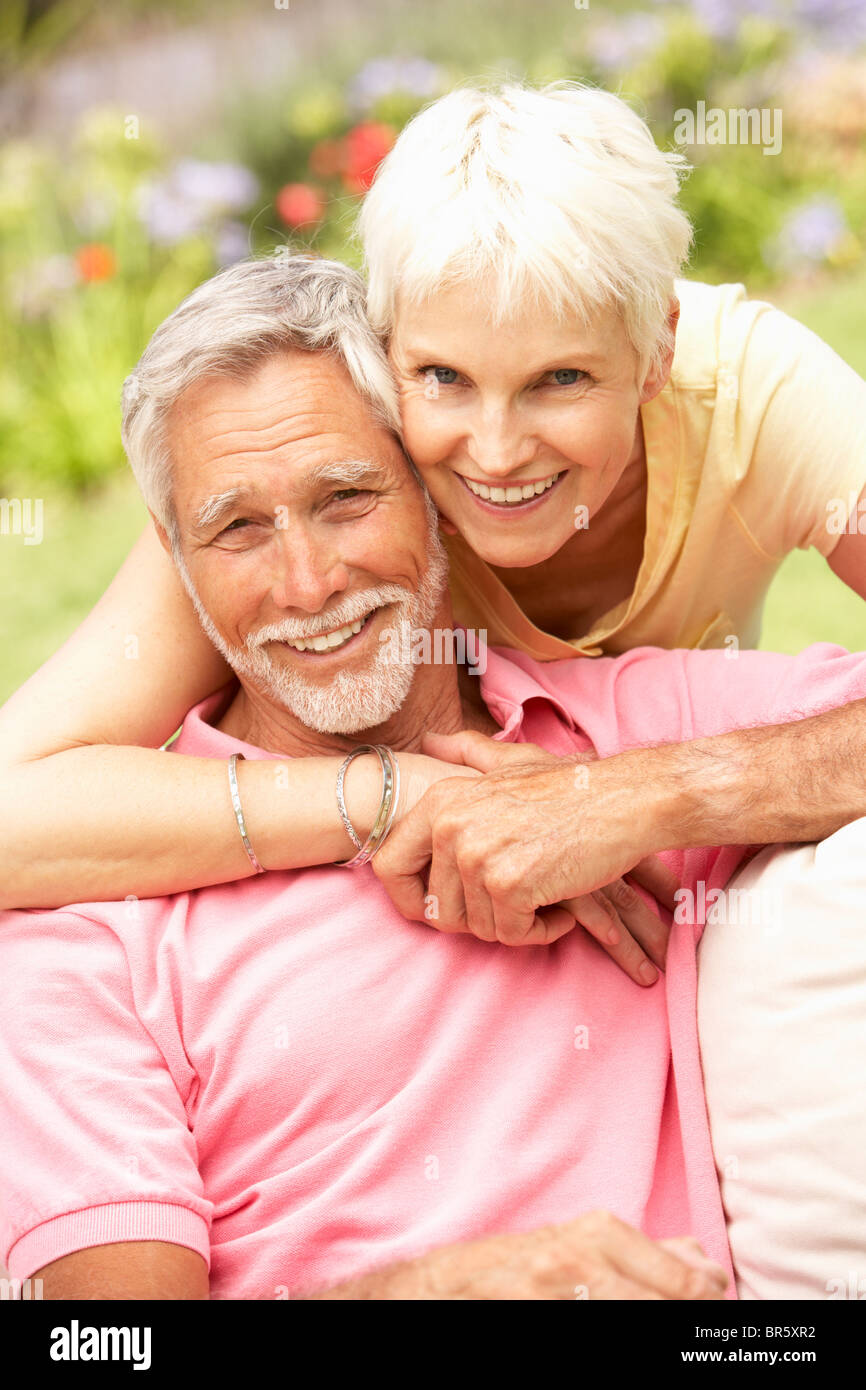 Senior Couple Relaxing In Garden Stock Photo - Alamy