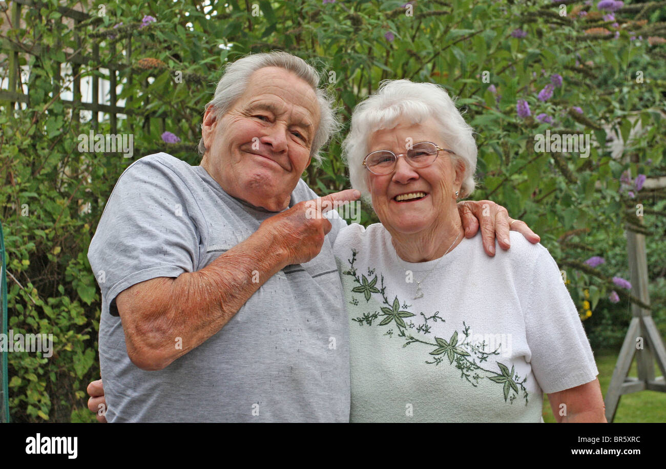 Two pensioners enjoying each others company. Stock Photo