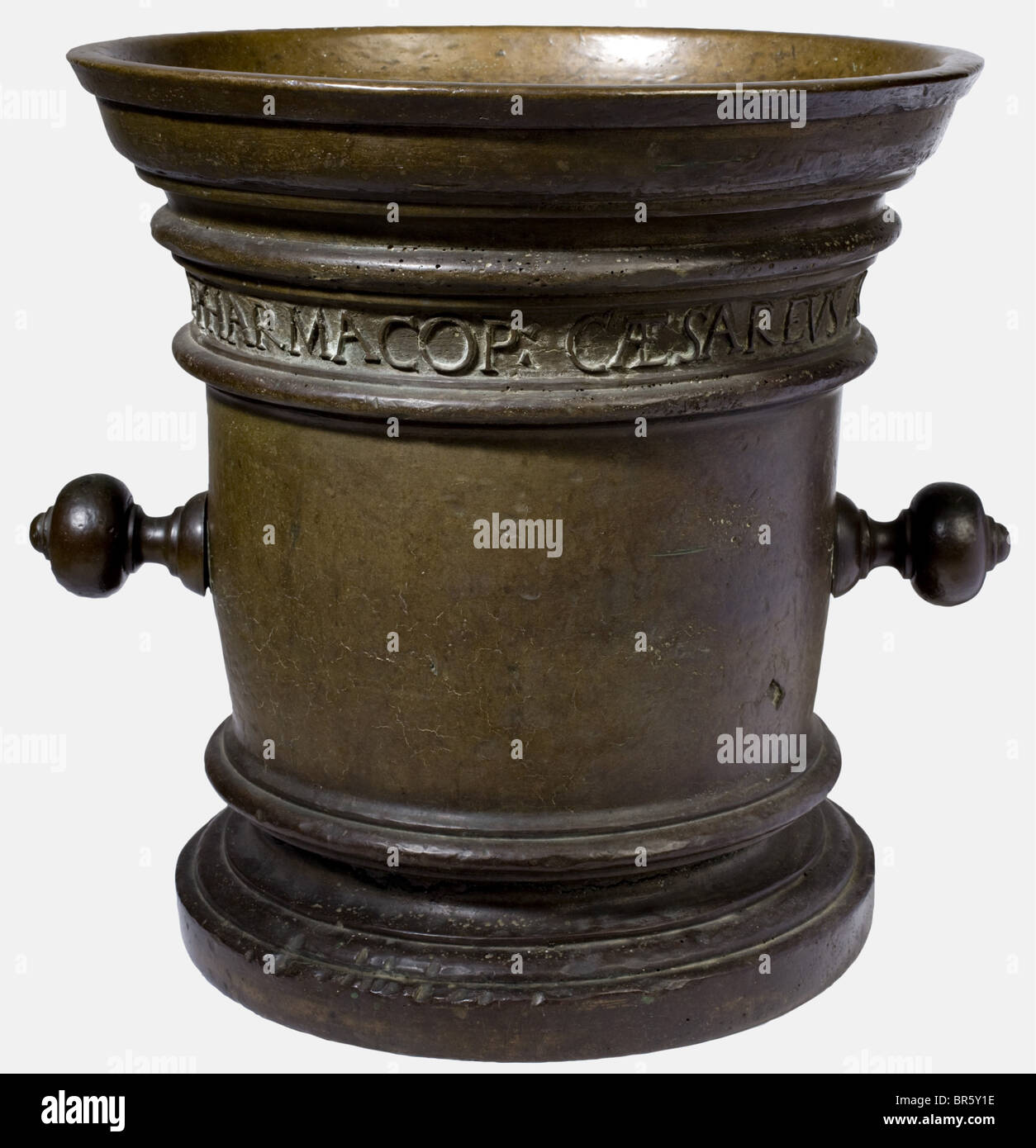 A large apothecary mortar, Regensburg, dated 1607 Bronze with beautiful age patina. Cylindrical body with offset base and widely flaring lip. On the sides two sturdy ball handles. Underneath the lip a continuous inscription band 'HERIC ERDELIO RATISBONA PHARMACOP CAESAREUS AO. 1607' (Erich Ertl?, court pharmacist to the Kaiser in Regensburg in 1607). Handles slightly loose, surrounding horizontal crack above the base plate. Height 38 cm, 37.5 cm in diameter. Heavy main mortar of a pharmacy in Regensburg, purveyor to the court of Rudolf II while he resided there, Stock Photo