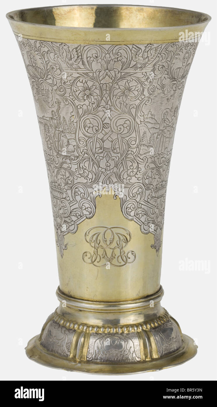 An engraved Frankfurt beaker, Master Johann Peter Beyer, circa 1740 Silver, partially gilt. Foil-curved foot with engraved decorative tendrils. Slender, to the top conically widening body. On all sides richly engraved with three cartouches with scenes from the New Testament, above each one a cartouche. Lavish framing of decorative scrolls and tendrils. At the lower rim high-grade, engraved English owner's name from the 19th century, consisting of a coat of arms, mirrored monogram and small grotesque scene. On the bottom stamped 'IPB' next to proofmark of Frankf, Stock Photo