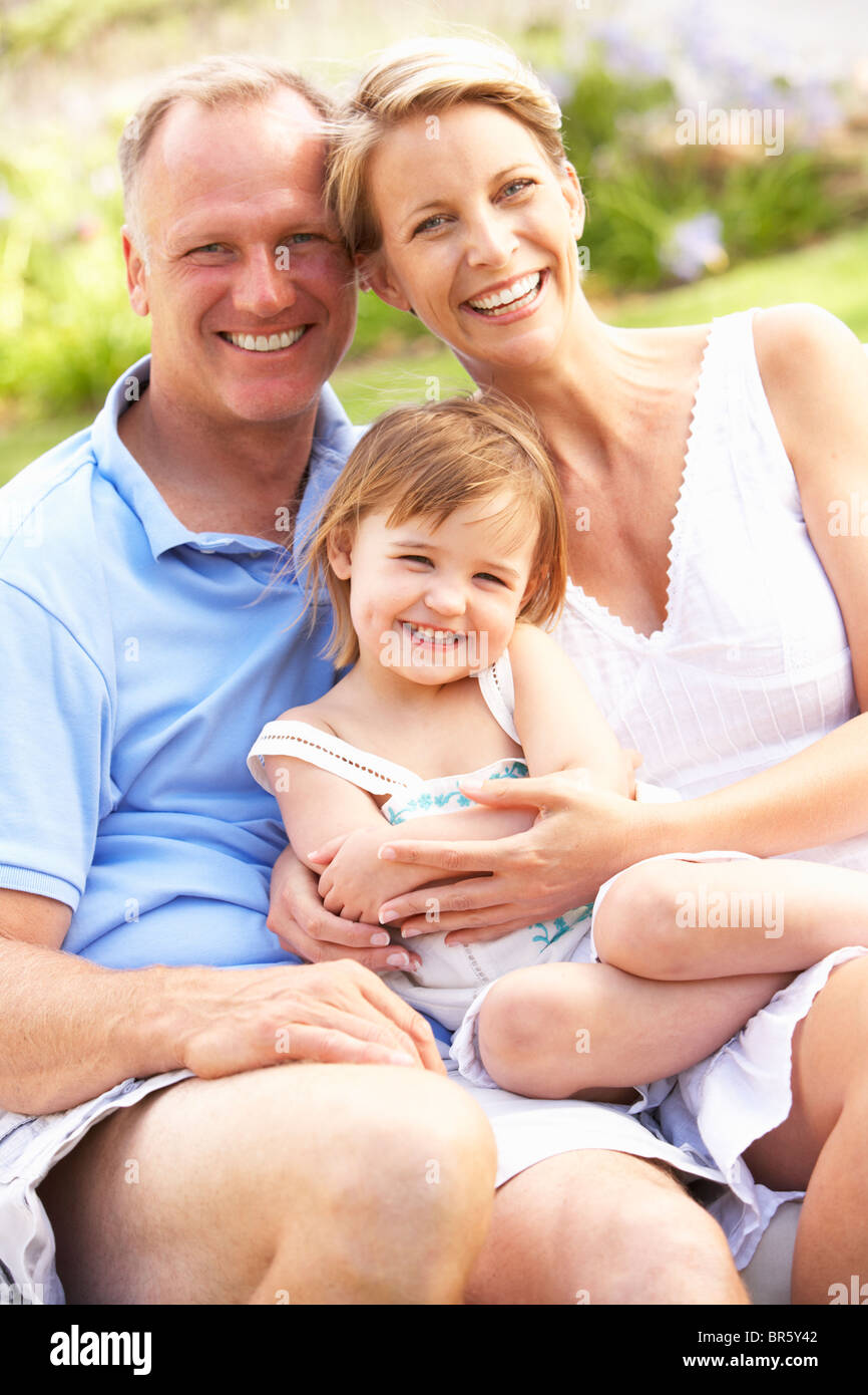 Family Relaxing In Garden Stock Photo