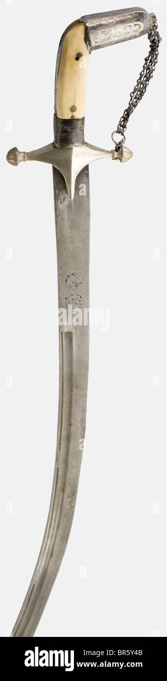 A silver-mounted Saudi-Arabian shamshir, circa 1900 A single-edged wootz-Damascus blade with fullers on both sides. An engraved inscription scroll on one side. An inscription cartouche and a stylised lion on the opposite side. Silver grip frame with a side chain and riveted bone grip scales. Leather-covered wooden scabbard with chased and engraved silver mountings. The attached suspension cord has two large ornamental tassels. Length 93.5 cm. historic, historical, 1900s, 20th century, 19th century, Ottoman Empire, thrusting, thrustings, blade, blades, melee wea, Stock Photo