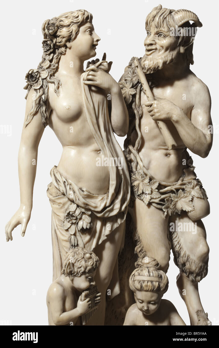 A large German ivory sculpture 'Pan and Nymph', probably Erbach, 2nd half of the 19th century Exceptional carving with depiction of the god of the woods, clad in vine leaves, holding a flute in his left hand, at his side a nymph with thrown-over cloth and flowers, at her feet a young satyr and a childlike nymph. Tiered socket with rich carvings, on the sides satyrs' heads, on the front as well as on the back figurative scenes and floral motifs. Not signed, but with assembling sign 'V' (front) and 'H' (back). Slightly damaged. Height 52.5 cm. CITES cer, Artist's Copyright has not to be cleared Stock Photo