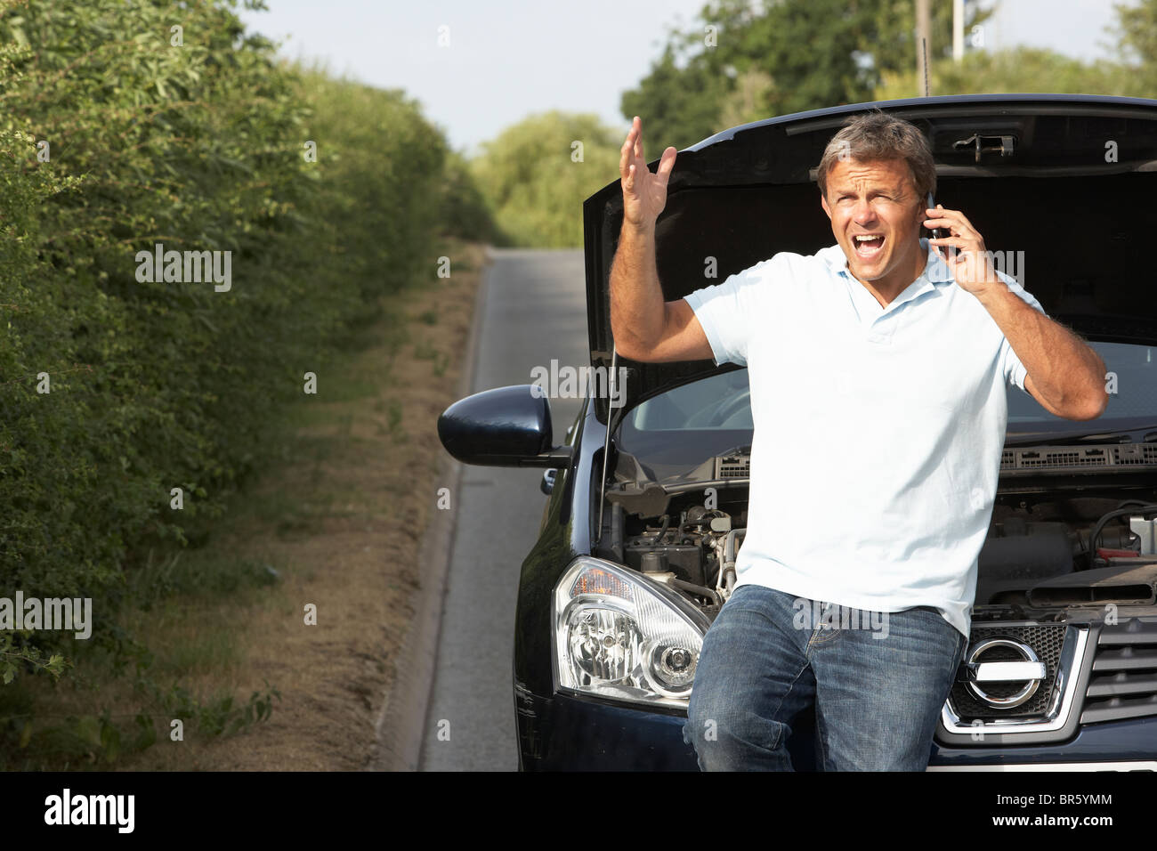 Driver Broken Down On Country Road Stock Photo