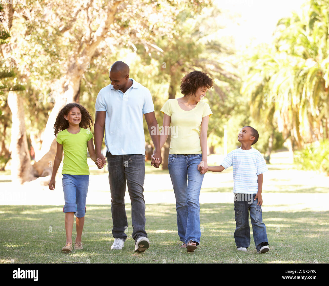 Portrait of Happy Family Walking In Park Stock Photo - Alamy