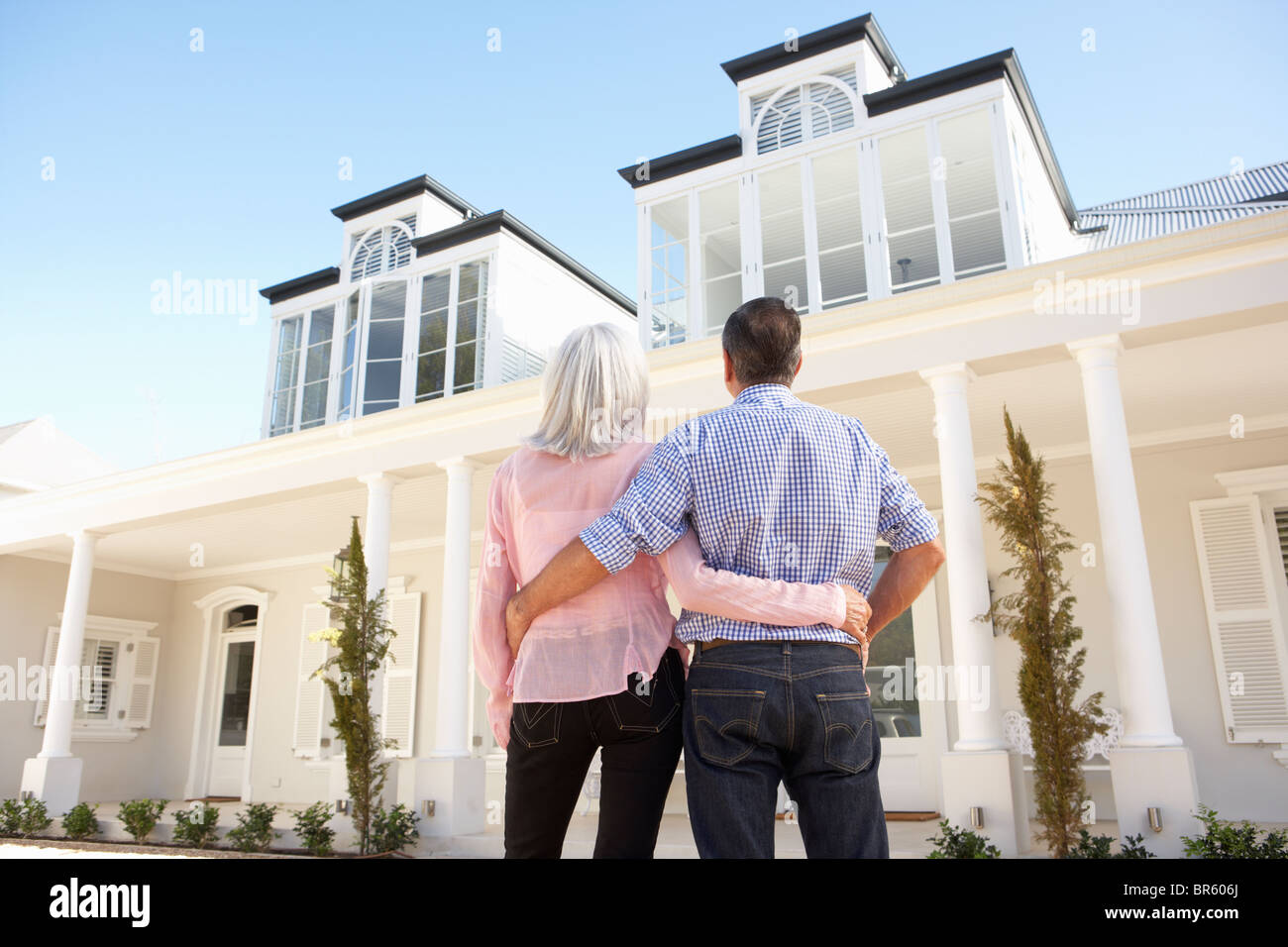 Senior Couple Standing Outside Dream Home Stock Photo - Alamy