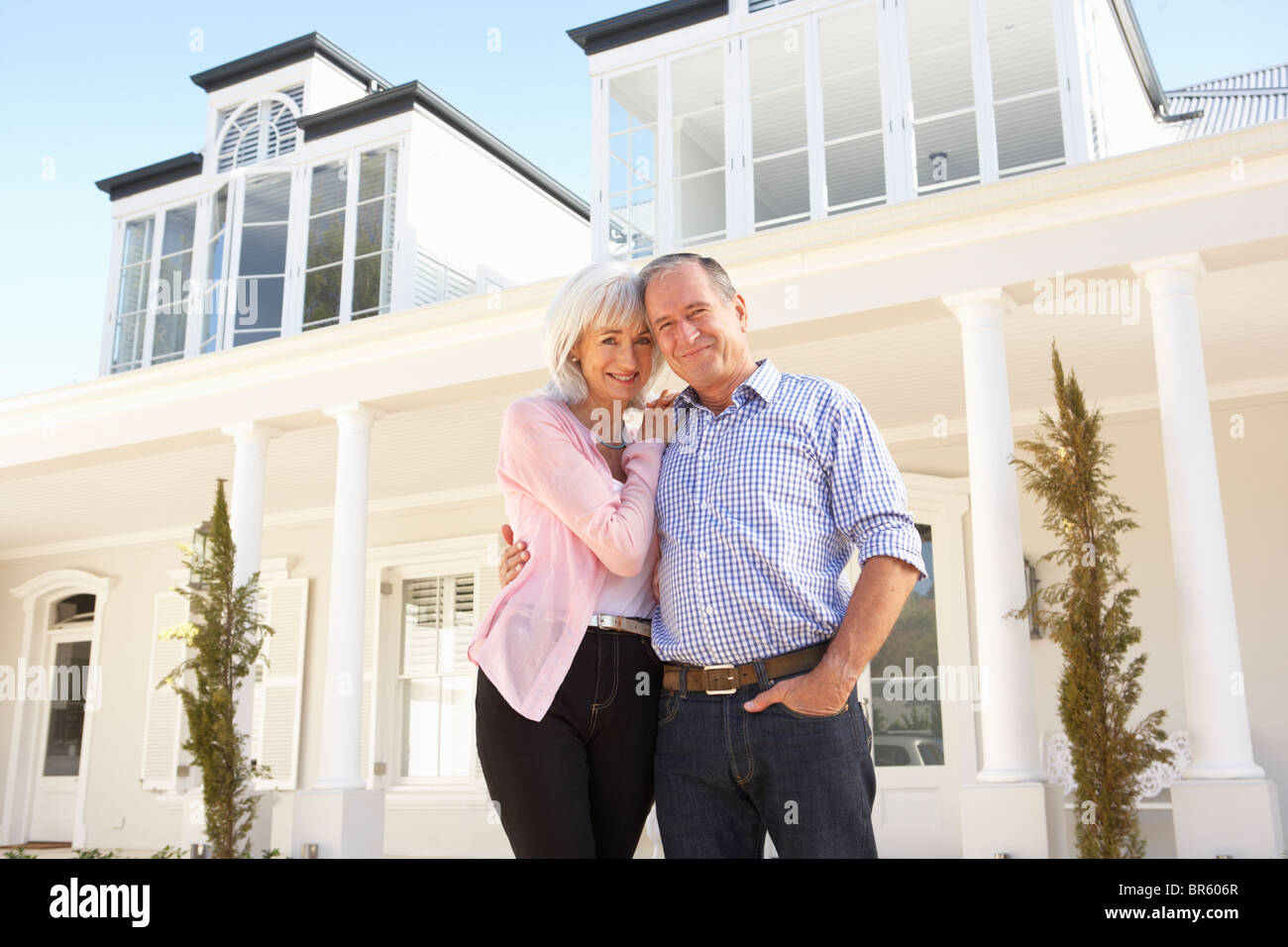 Senior Couple Standing Outside Dream Home Stock Photo - Alamy