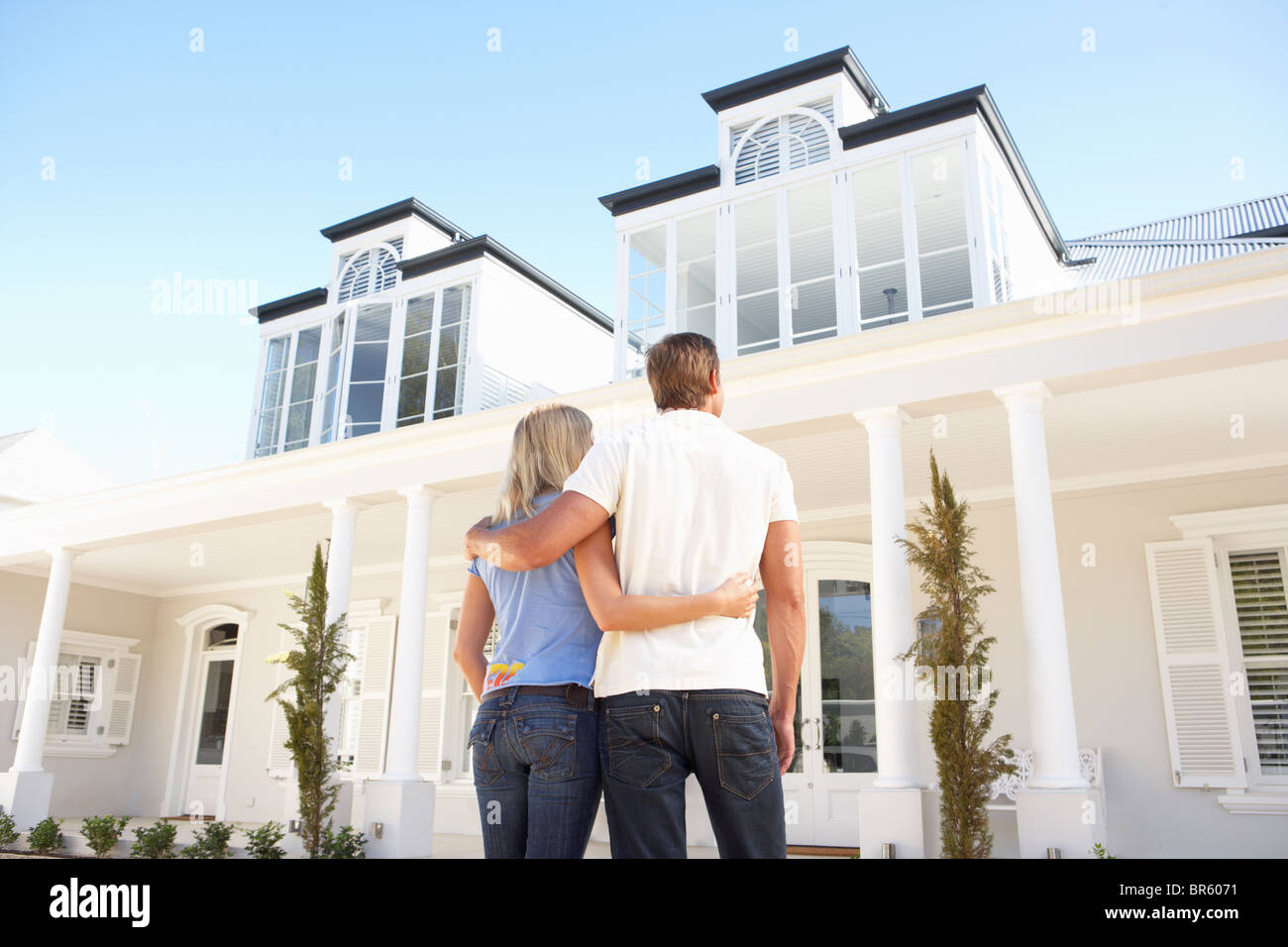 Young Couple Standing Outside Dream Home Stock Photo - Alamy