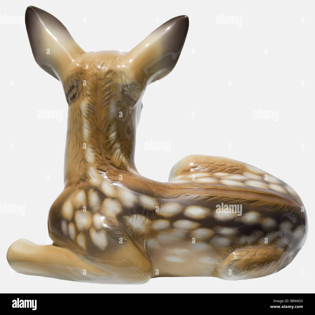 A standing and a recumbant roe deer fawn, coloured versions, Allach Porcelain Factory Design by Prof. Theodor Kärner. Model numbers '41' and '84'. Each of glazed, coloured porcelain. The signature, 'Prof. Th. Kärner', and model numbers are on the bottom and the stomach respectively. The standing fawn bears the manufacturer's press mark, and the recumbant figure bears the mark in the octagon in underglaze green . Heights 28.3 and 16.2 cm. Undamaged condition. From the legacy of Prof. Theodor Kärner, with written confirmation concerning the purchase from Kärner's, Stock Photo