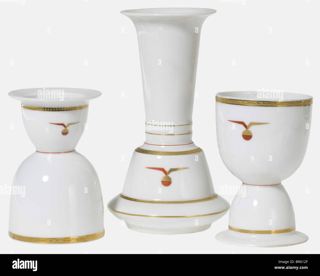 Dornier DO X 1929, 47 porcelain pieces from the service aboard White, glazed porcelain with decorative lines as well as a stylised, winged globe in gold and red. On the bottom manufacturer's mark in underglaze green 'Gräf & Krippner Selb Bavaria' as well as golden silhouette of the hydroplane over 'DO X 1929' and 'decoration by Marcel Dornier Langenargen'. Consisting of: Five dining plates, diameter 25.5 cm. Twelve soup plates, diameter 25.2 cm. 15 dessert plates, three with and twelve without the globe emblem, but all except one with the golden DO-X on the bot, Stock Photo