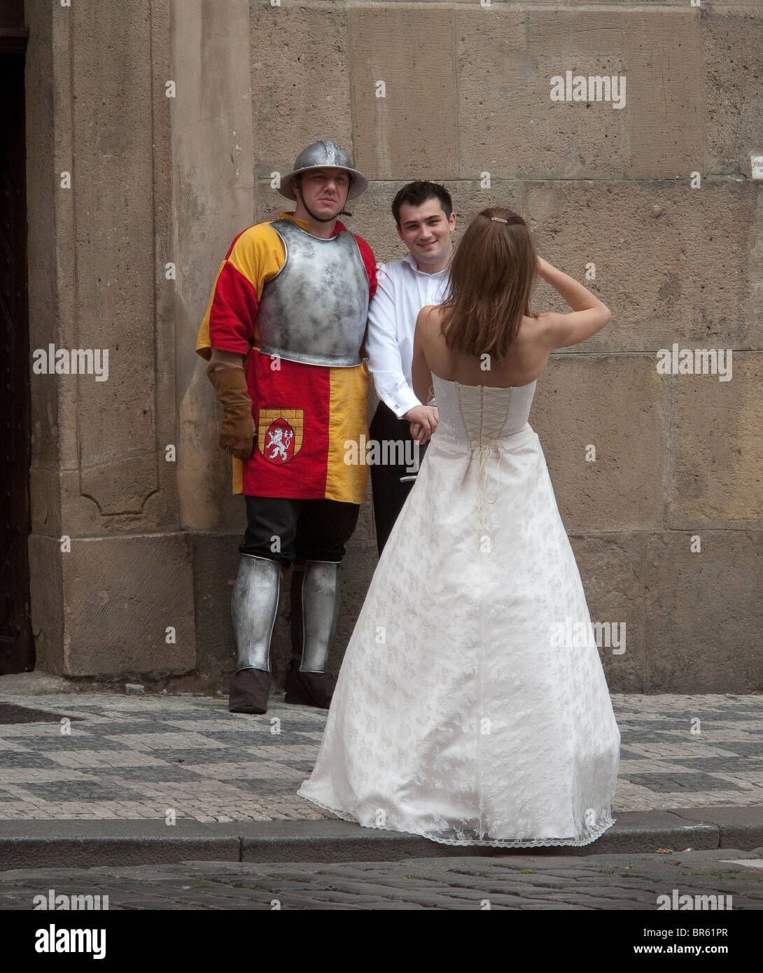 Bride taking photo of groom and ancient soldier Stock Photo