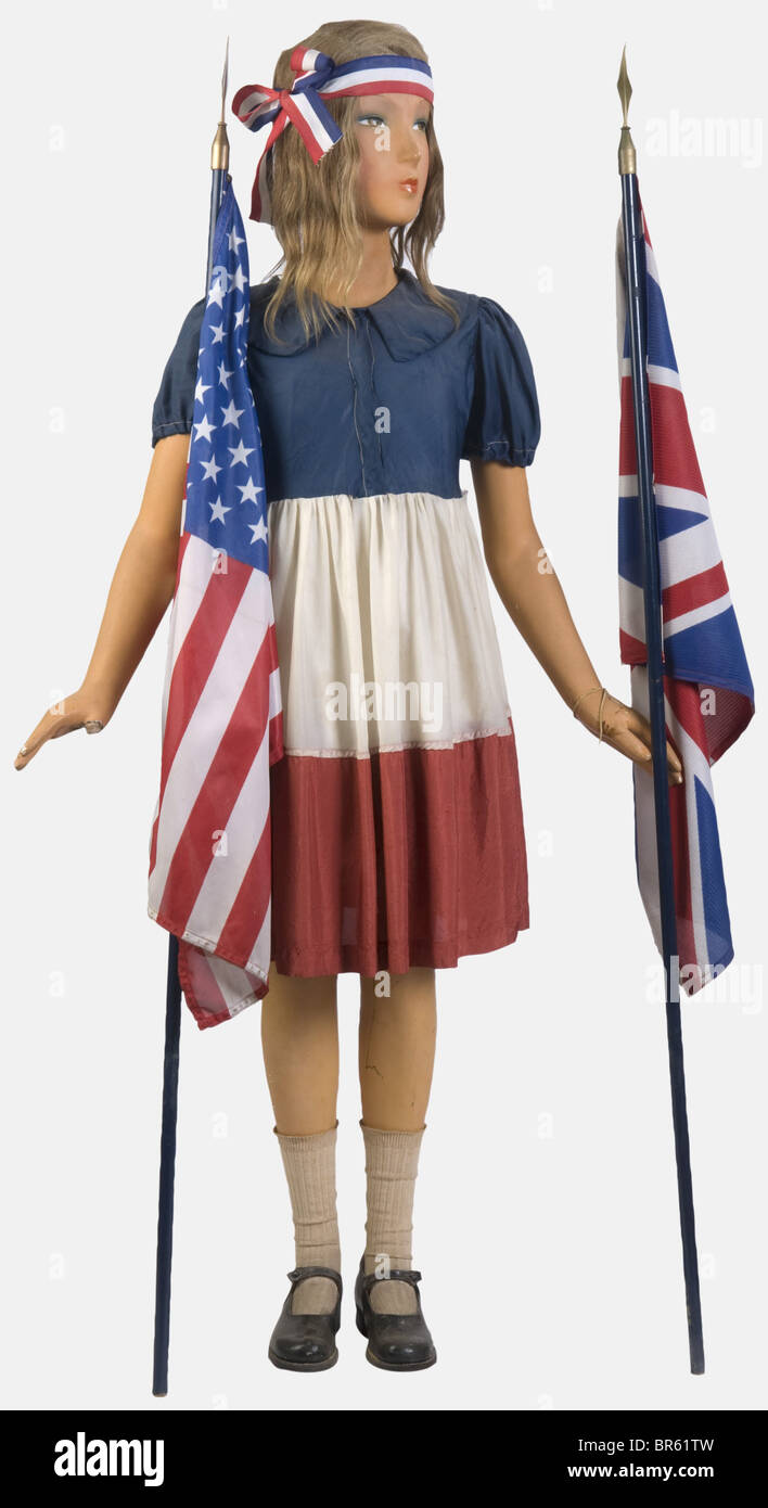 A girl celebrating the Liberation, on mannequin, with a tricolor headband. She wears a dress made of blue, white and red rayon, a white cloth underskirt, cotton knickers, long cotton socks and light sandals made of black glossy leather. The mannequin holds the British flag in one hand and the American one in the other. Living reconstruction from the summer of 1944. historic, historical, people, 1930s, 20th century, object, objects, stills, clipping, clippings, cut out, cut-out, cut-outs, flag, flags, insignia, symbol, symbols, emblem, emblems, Stock Photo