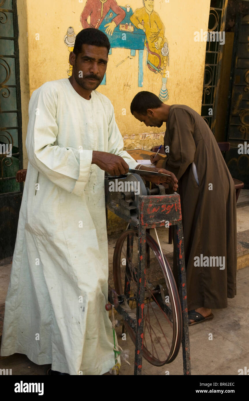 knife sharpener in the bazaar in Aswan Egypt Stock Photo