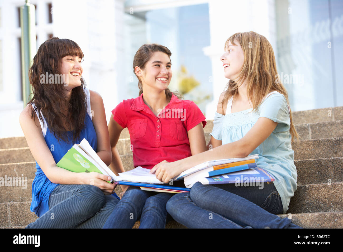 Group Of Teenage Female Friends Sitting On College Steps Outside Stock Photo