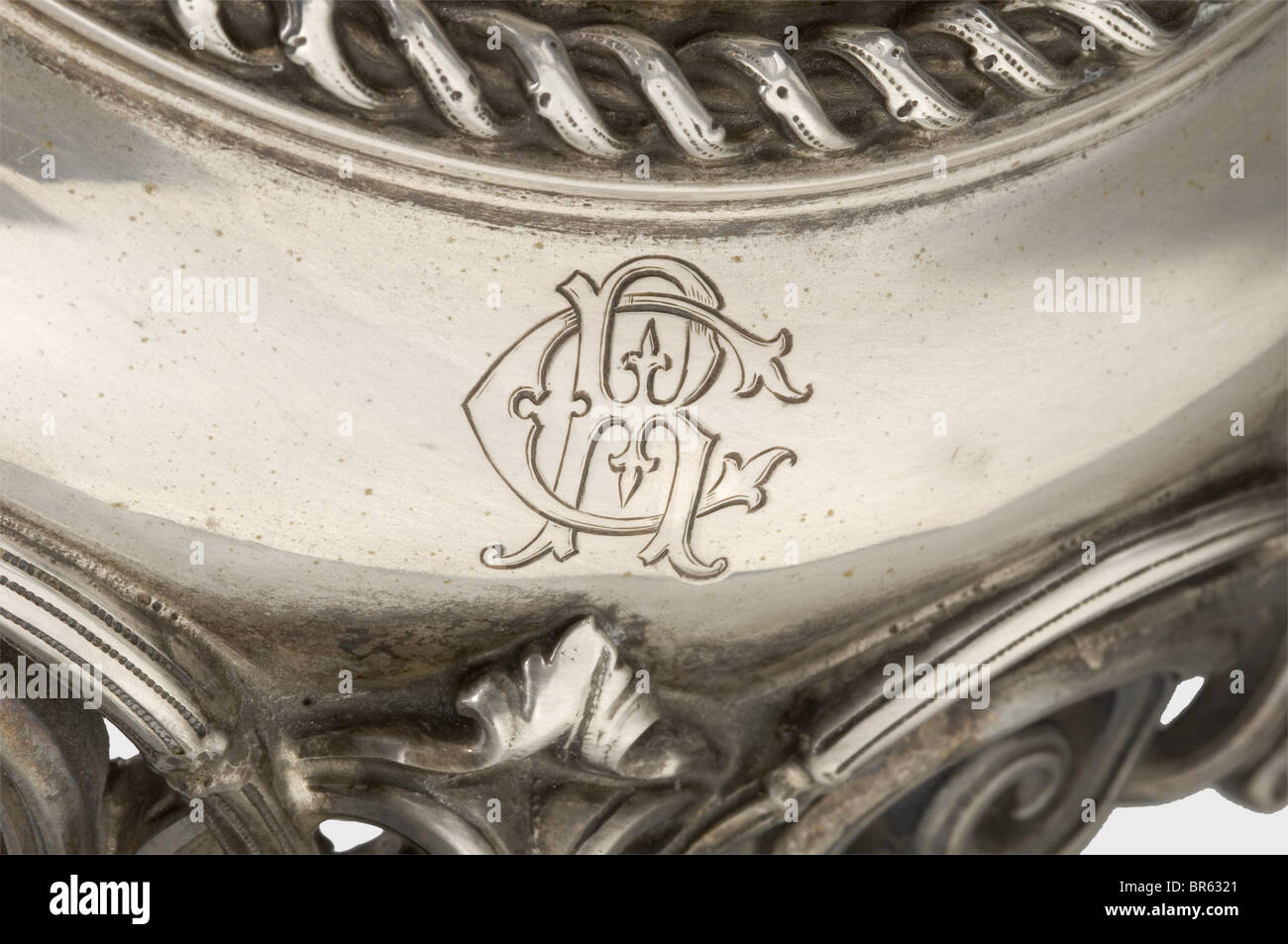 A tazza centrepiece, ca. 1870. Silver foot (no hallmarks). The stem with four three-dimensional genii symbolising fishing, viticulture, hunting and crop/livestock farming. The foot with engraved cipher 'CR'. Height of the stem 36 cm, weight ca. 1750 g. Glass bowl supplemented by moulded glass, diameter 35 cm. historic, historical, 19th century, handicrafts, handcraft, craft, object, objects, stills, clipping, clippings, cut out, cut-out, cut-outs, insignia, symbols, symbol, emblem, emblems, Stock Photo