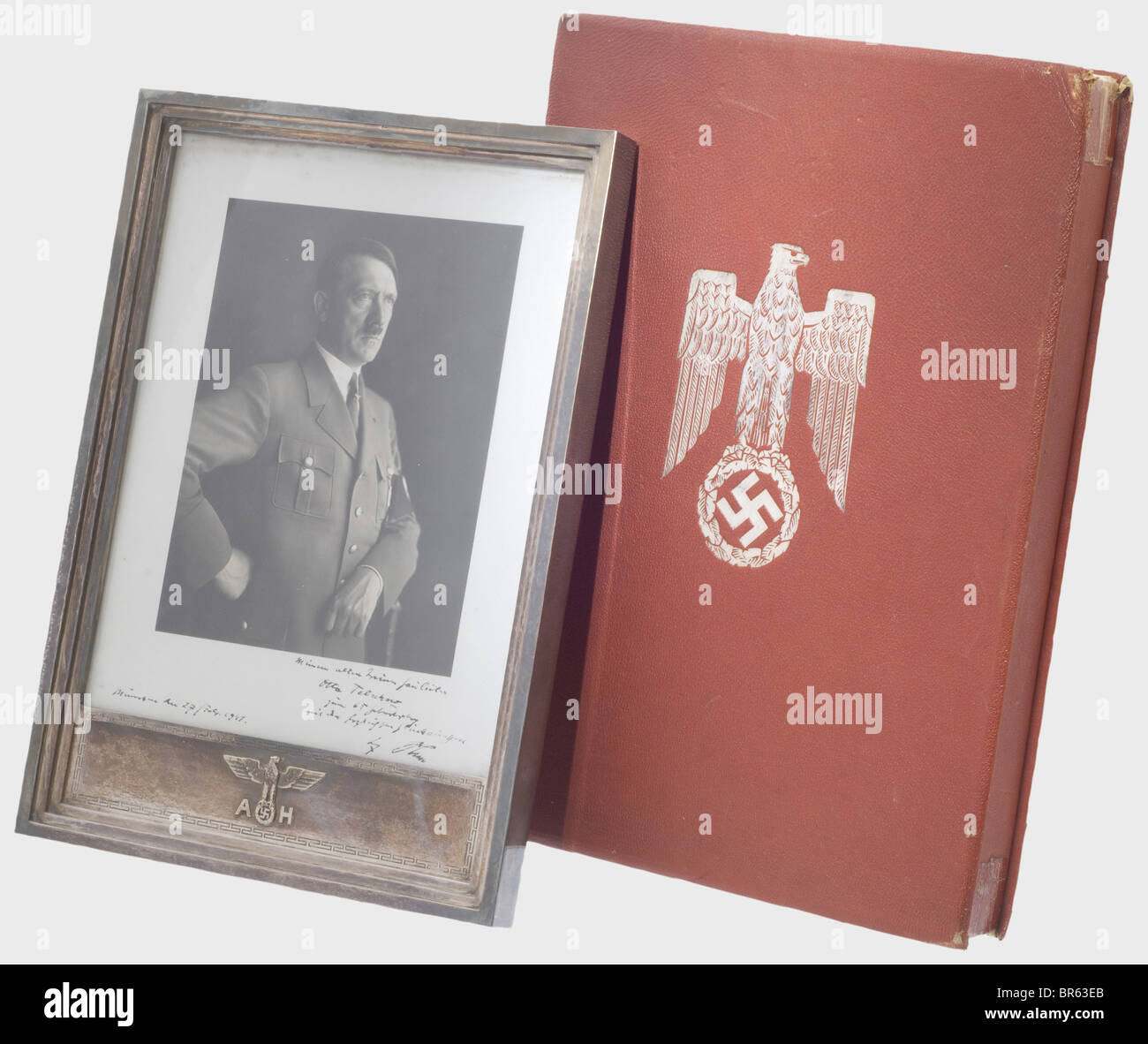 Adolf Hitler - a silver presentation frame with dedication photograph, 1941 to Gauleiter Otto Telschow. Half portrait by Hoffmann of Adolf Hitler in party uniform. Dedication and signature (transl.) 'To my old and loyal Gauleiter Otto Telschow on, with red Morocco leather cover (dented, the edges glued), silver-stamped national eagle and velvet lining. Otto Telschow (1876 - 1945) resigns from the DVFP to join the NSDAP in 1925 and becomes in February of the same year Gauleiter of Lüneburg-Stade. 1928 this gau is expanded to become Gau Hannover-Ost, Telschow rem, Stock Photo