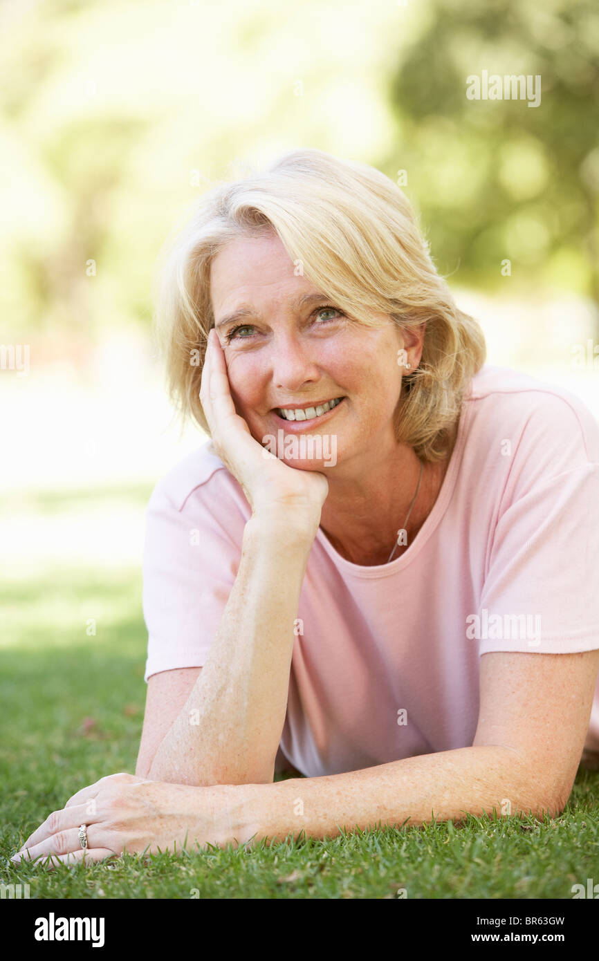 Portrait smiling senior woman lying grass hi-res stock photography and ...