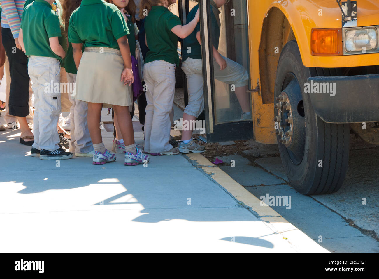 Uniformed school children board school bus in Baton Rouge, Louisiana, USA Stock Photo