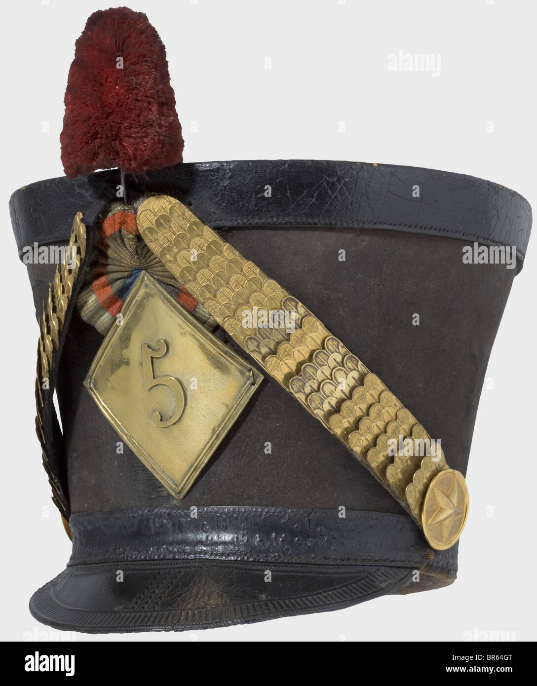 A shako for officers of the 5th Hussars Regiment, according to the regulation of 1810. Large, black felt body (crescent-shaped crack on the front). Adjustable head band and visor of black leather with tooled decoration. Brass chinscales on embossed star rosettes. Rhomboidal, embossed emblem according to the regulation of 1812 with the number '5'. Leather cockade and plume (pompon is missing). Leather sweatband and linen lining. Band leather and sweatband somewhat chapped. Traces of age and usage. The 5th Hussars Regiment fought in the following battles: Eylau, , Stock Photo