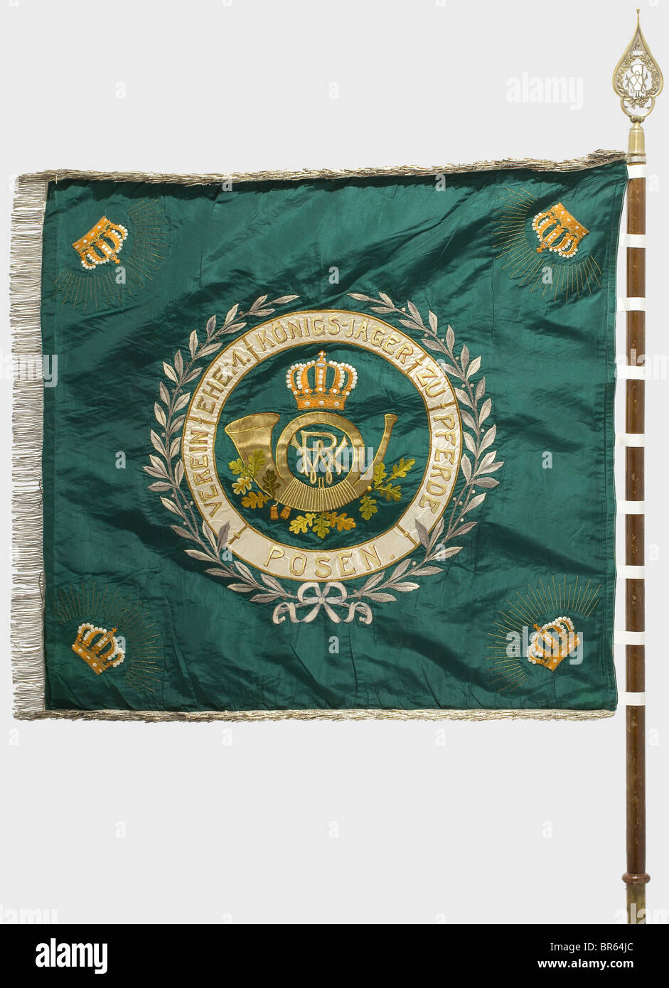 An association banner for veterans, of the Royal Mounted 'Jägers', Posen. Green silk with gold embroidery, displaying a hunting horn with a cipher surrounded by a laurel wreath, and crowns in the corners. The back is of white silk displaying a Prussian eagle in an oak leaf wreath with the 'WR' cipher in the corners. Dimensions 110 x 106 cm. Surrounded by silver fringe. The attachment loops have been replaced. On the top half of the pole a brass finial displaying the monarch's cipher. Length of the pole 180 cm. Also a picture postcard showing the presentation of, Stock Photo