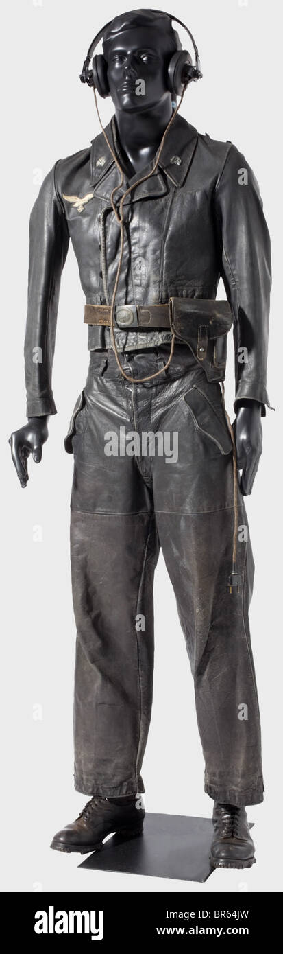 A protective black leather Luftwaffe panzer uniform., A smooth, black leather tunic in the SS-pattern with a covered button flap, black plastic buttons, a collar bearing metal deaths heads, and a hand-sewn, machine-embroidered chest eagle. Shoulder boards missing. Unlined, with only the interior pocket and hems of linen. The maker's stamp is barely detectable. Matching black leather trousers with grey cotton lining. The adjustable laces on the legs and the separate belt are missing. Both garments have obviously been worn. Very rare set. Also a belt with a blue , Stock Photo