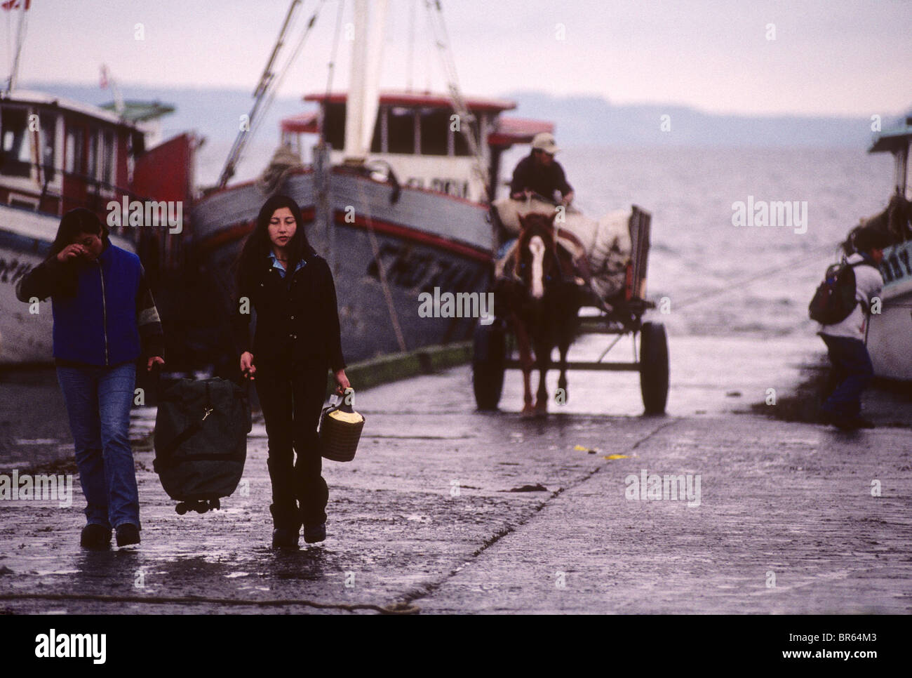 Girls on the boat Ramp at Achao Isla Quinchao ChiloŽ archipelago Stock Photo